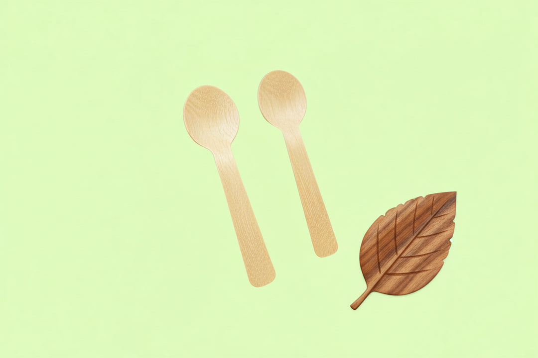 Two wooden spoons on a light green background